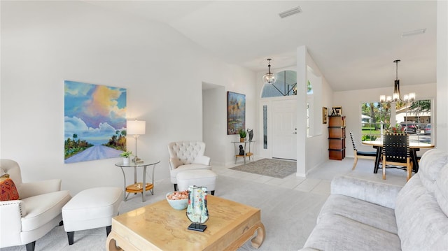 living room with an inviting chandelier, vaulted ceiling, and light colored carpet