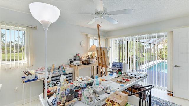 office area with ceiling fan and a textured ceiling