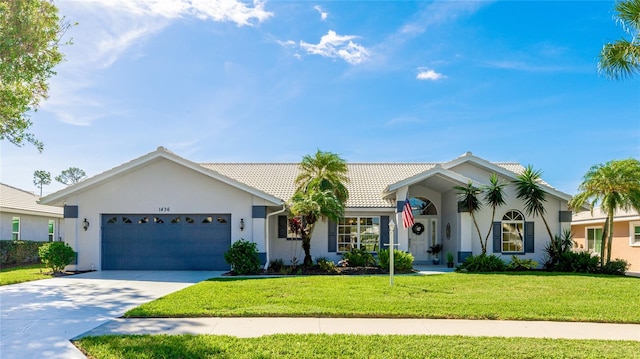 single story home with a garage and a front lawn