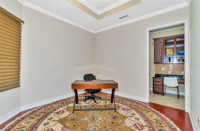 office space with light hardwood / wood-style floors and crown molding