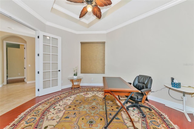 office space with french doors, tile patterned floors, ornamental molding, a raised ceiling, and ceiling fan