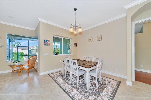 dining area with a chandelier, light tile patterned floors, and crown molding