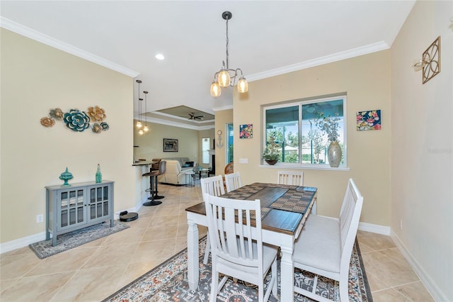 tiled dining area featuring a chandelier and ornamental molding