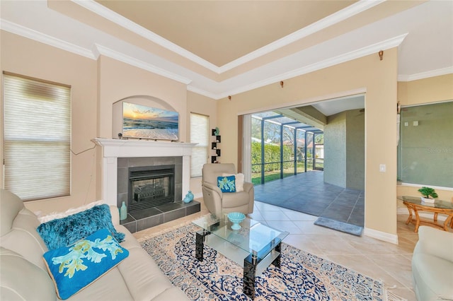 living room with a tile fireplace, crown molding, and tile patterned flooring