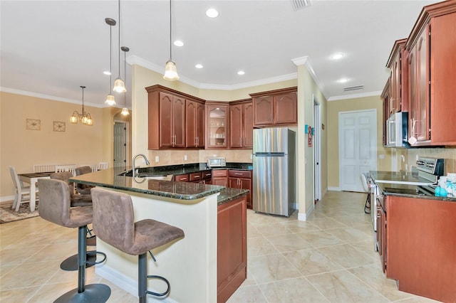 kitchen with appliances with stainless steel finishes, crown molding, sink, light tile patterned floors, and hanging light fixtures