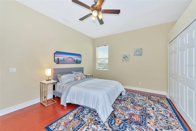 bedroom featuring hardwood / wood-style floors, a closet, and ceiling fan