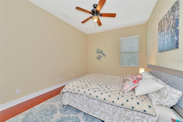 bedroom with ceiling fan and wood-type flooring