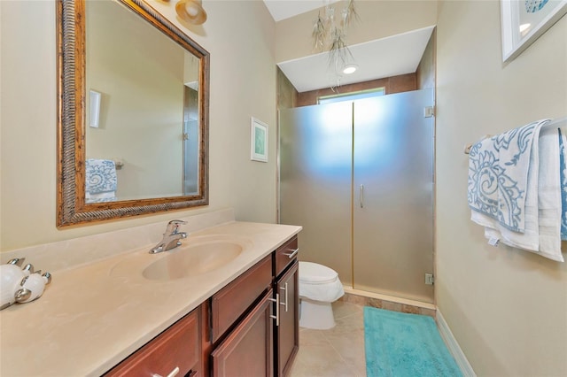 bathroom with toilet, vanity, tile patterned floors, and walk in shower