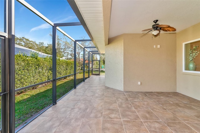 unfurnished sunroom with ceiling fan