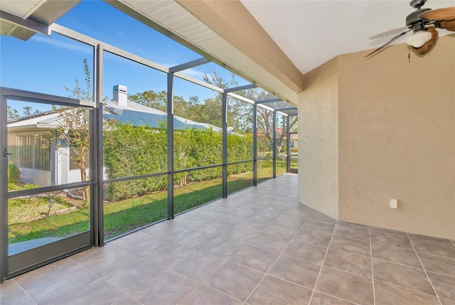 unfurnished sunroom with ceiling fan