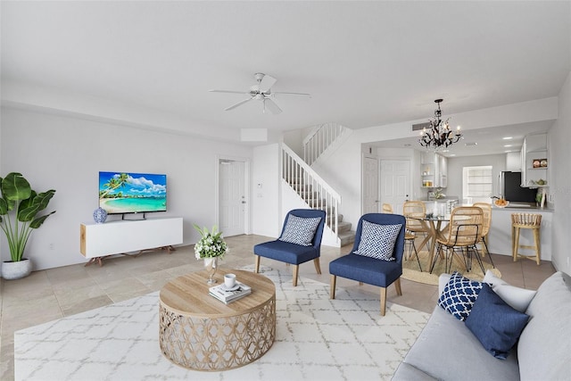 living room with ceiling fan with notable chandelier