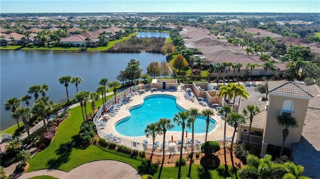 view of pool featuring a water view and a patio