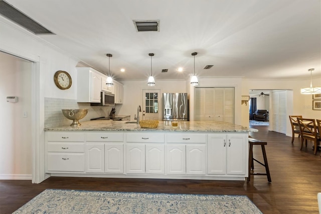 kitchen with ceiling fan, dark hardwood / wood-style flooring, decorative light fixtures, white cabinets, and appliances with stainless steel finishes