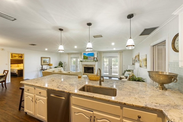 kitchen featuring french doors, sink, stainless steel dishwasher, dark hardwood / wood-style floors, and light stone counters