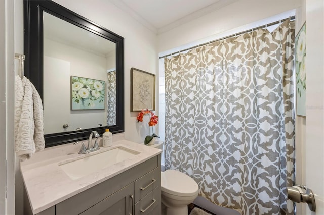 bathroom featuring vanity, toilet, and ornamental molding