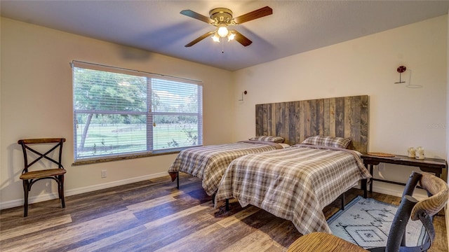 bedroom featuring ceiling fan and dark hardwood / wood-style floors