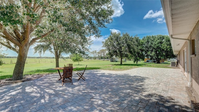 view of patio / terrace featuring a rural view and central AC