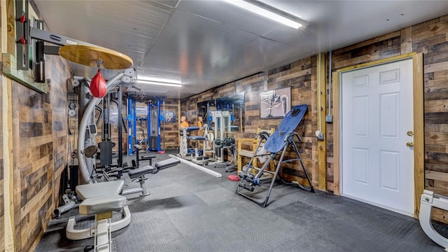 workout area with carpet and wood walls