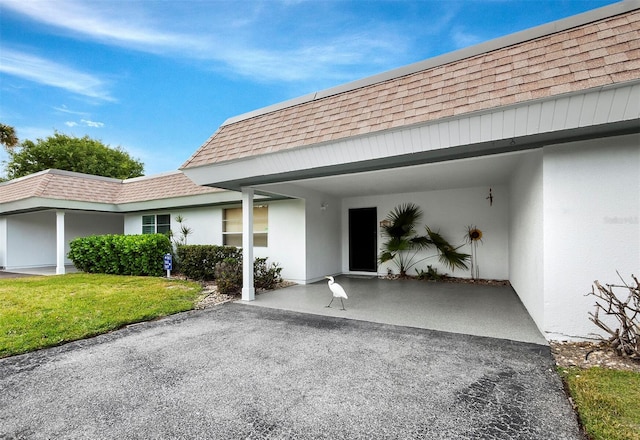 doorway to property with a yard