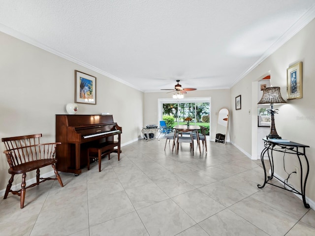 tiled dining space with a textured ceiling, ceiling fan, and ornamental molding