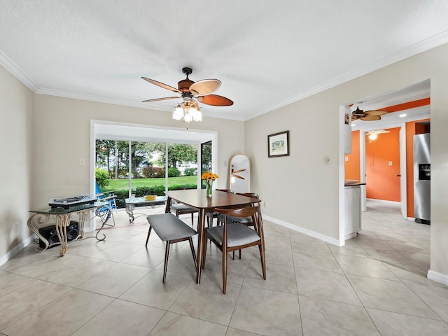 dining space featuring a textured ceiling, ceiling fan, ornamental molding, and light tile patterned flooring