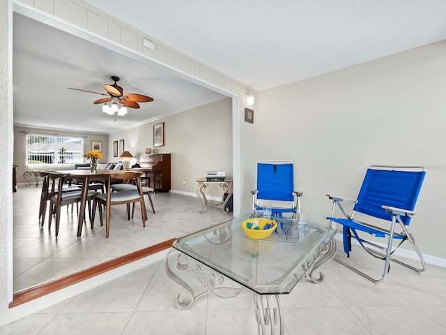 dining space featuring light tile patterned floors, ceiling fan, and crown molding