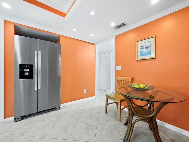 tiled dining space with crown molding