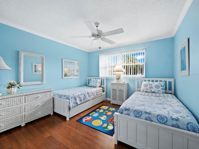 bedroom with ceiling fan, crown molding, dark wood-type flooring, and a textured ceiling