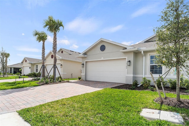 view of front of home featuring a garage and a front lawn