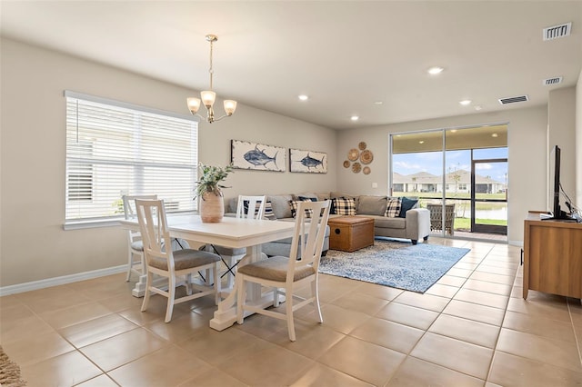 dining space featuring a notable chandelier and light tile patterned flooring