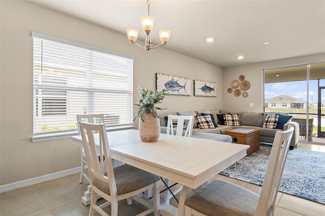 dining area with light tile patterned flooring and a chandelier