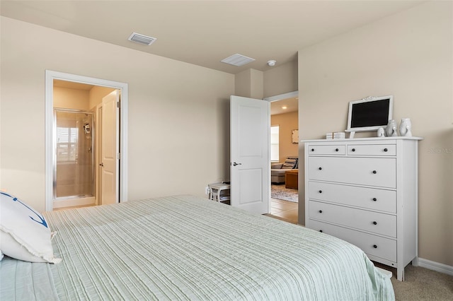 carpeted bedroom featuring ensuite bath