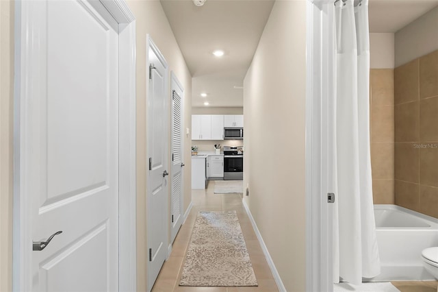 corridor featuring light tile patterned floors