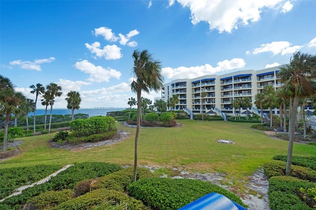 view of property's community featuring a yard and a water view