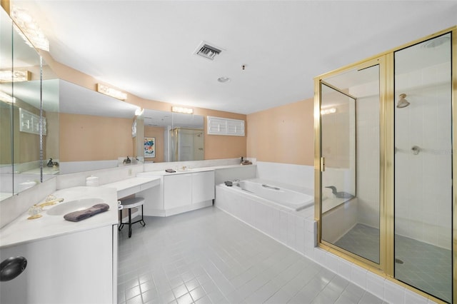 bathroom with tile patterned floors, vanity, and shower with separate bathtub