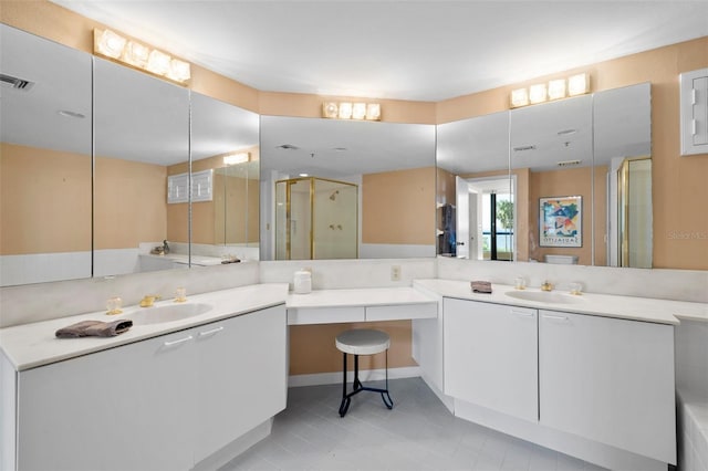 bathroom with tile patterned floors, vanity, and walk in shower