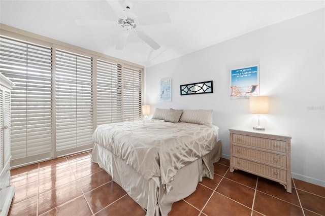 tiled bedroom featuring ceiling fan and lofted ceiling