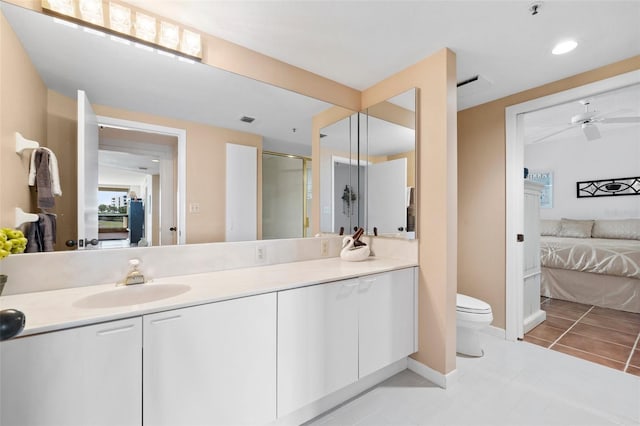 bathroom featuring tile patterned flooring, vanity, ceiling fan, and toilet