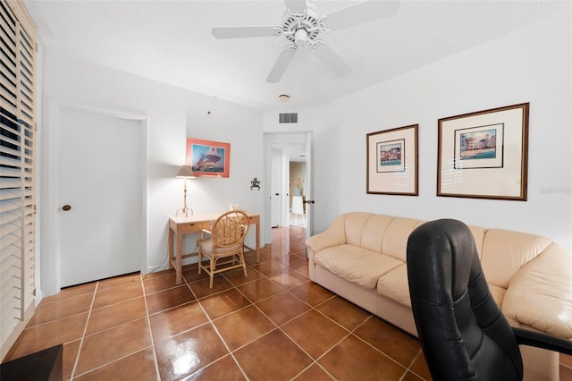 tiled living room with ceiling fan