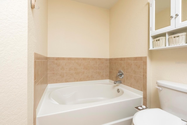 bathroom with a washtub and toilet