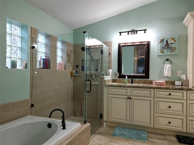 bathroom with plus walk in shower, vanity, and tile patterned flooring