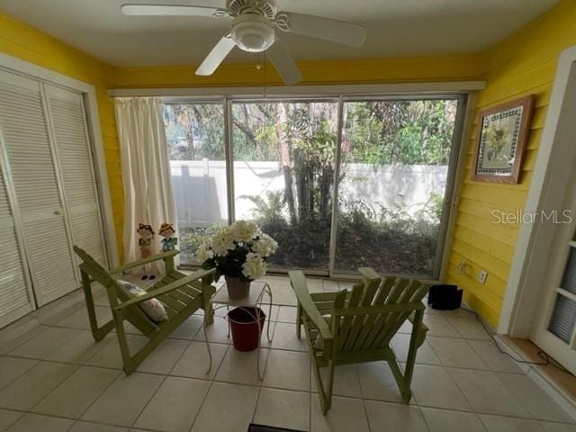 sunroom / solarium featuring ceiling fan