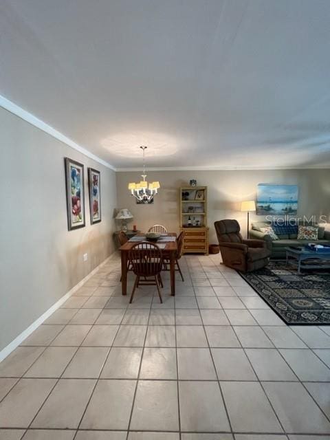 dining space featuring a notable chandelier, crown molding, and light tile patterned flooring