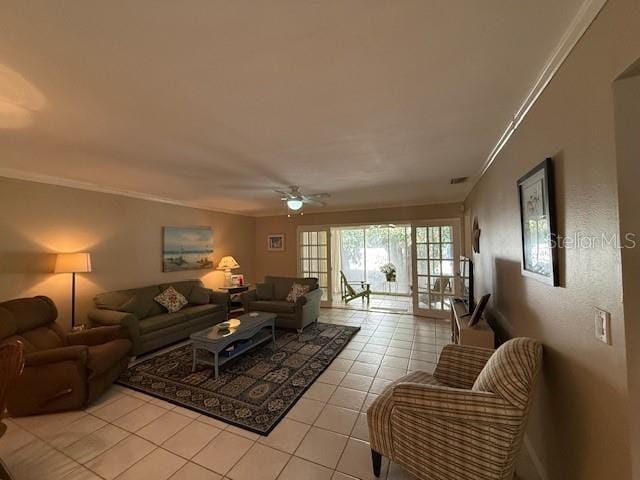 living room featuring ceiling fan, ornamental molding, and light tile patterned floors