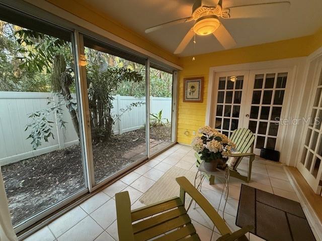 unfurnished sunroom featuring french doors and ceiling fan