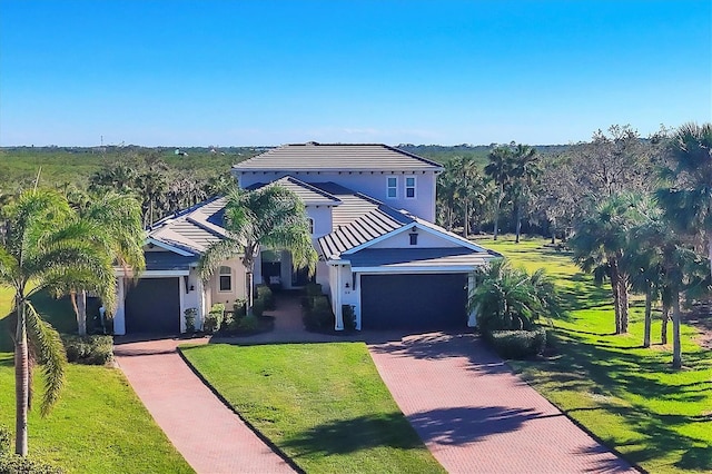 view of front of property with a garage and a front yard