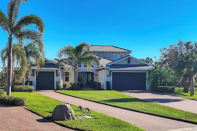 view of front of house featuring a garage and a front lawn