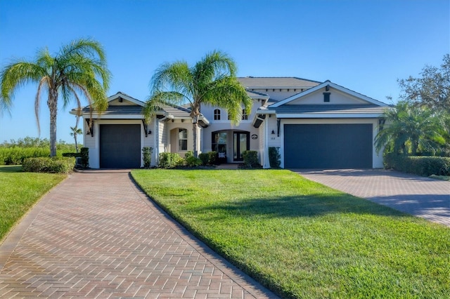 view of front of home with a garage and a front yard