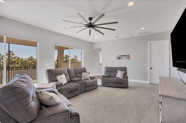 carpeted living room featuring ceiling fan