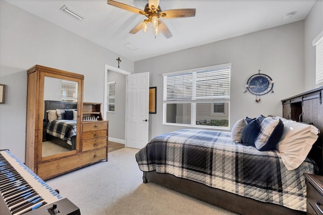 bedroom featuring ceiling fan and light carpet